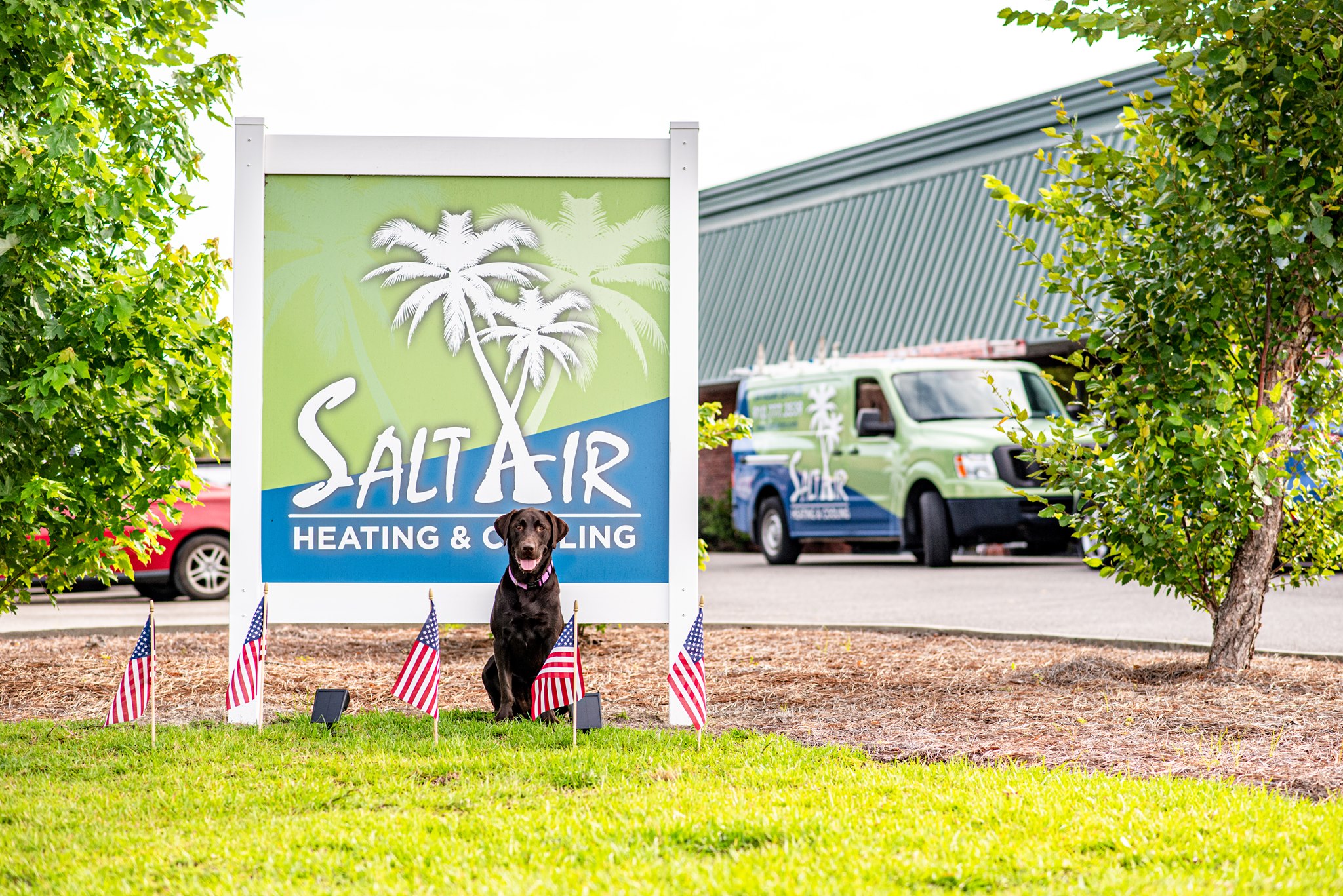 Salt Air Heating & Cooling sign with a dog and a company service van